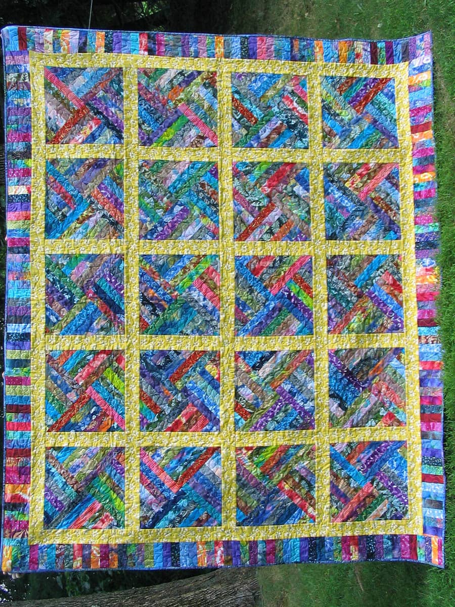 A custom quilt with geometrically arranged batiks is bold and colorful